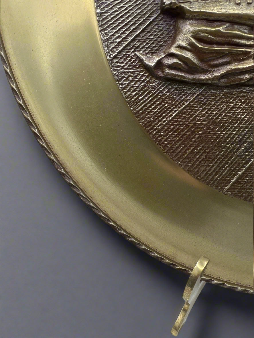 Close-up of a decorative metal object with intricate designs on a white background