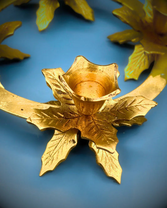 Gold leaf candle holder on a blue background