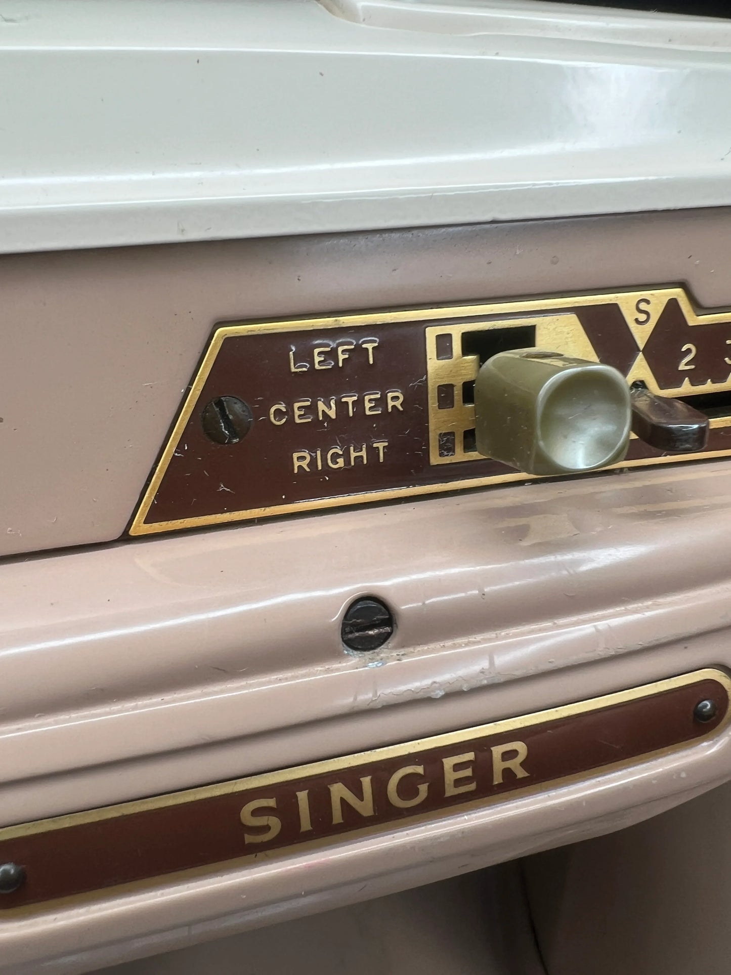 Singer sewing machine with control panel and 'Singer' branding.
