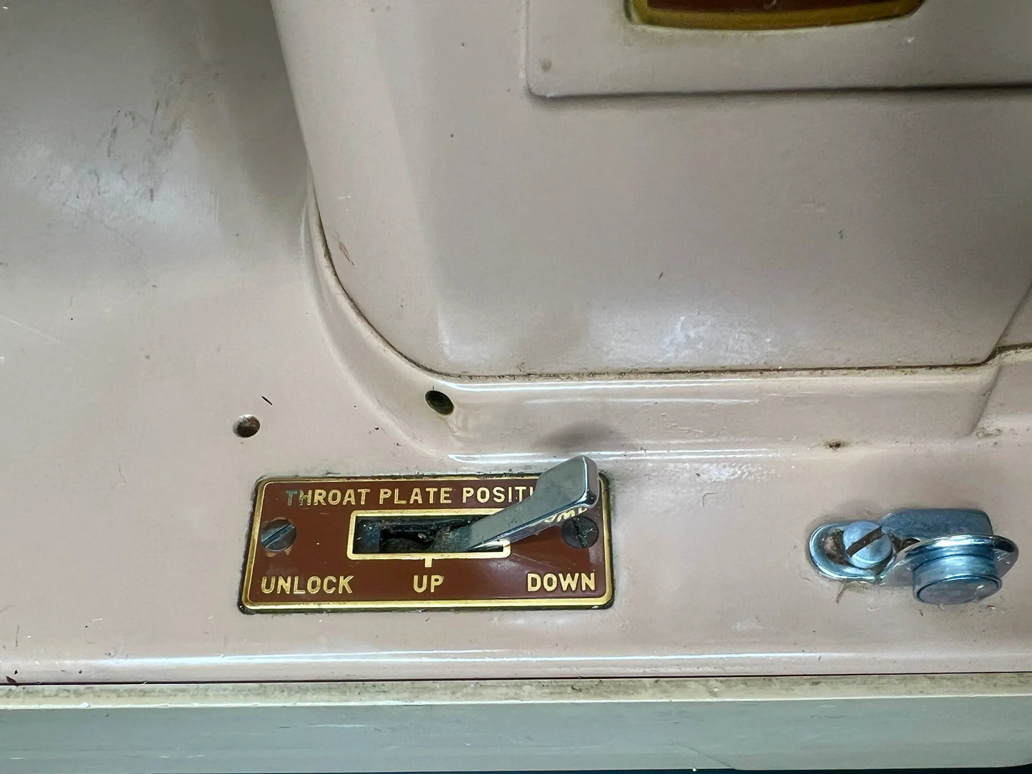 Control panel with 'Unlock Up Down' label on aa vintage Singer 403A Slant-o-Matic sewing machine