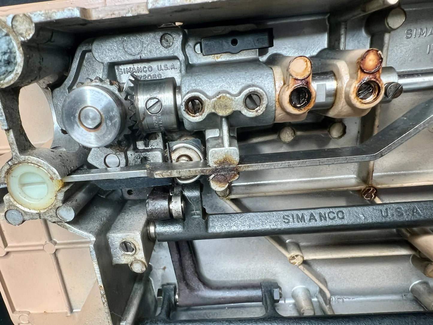 Close-up of engine component with 'Simanco U.S.A.' branding on interior mechanics of Singer 403A Slant-O-Matic sewing machine
