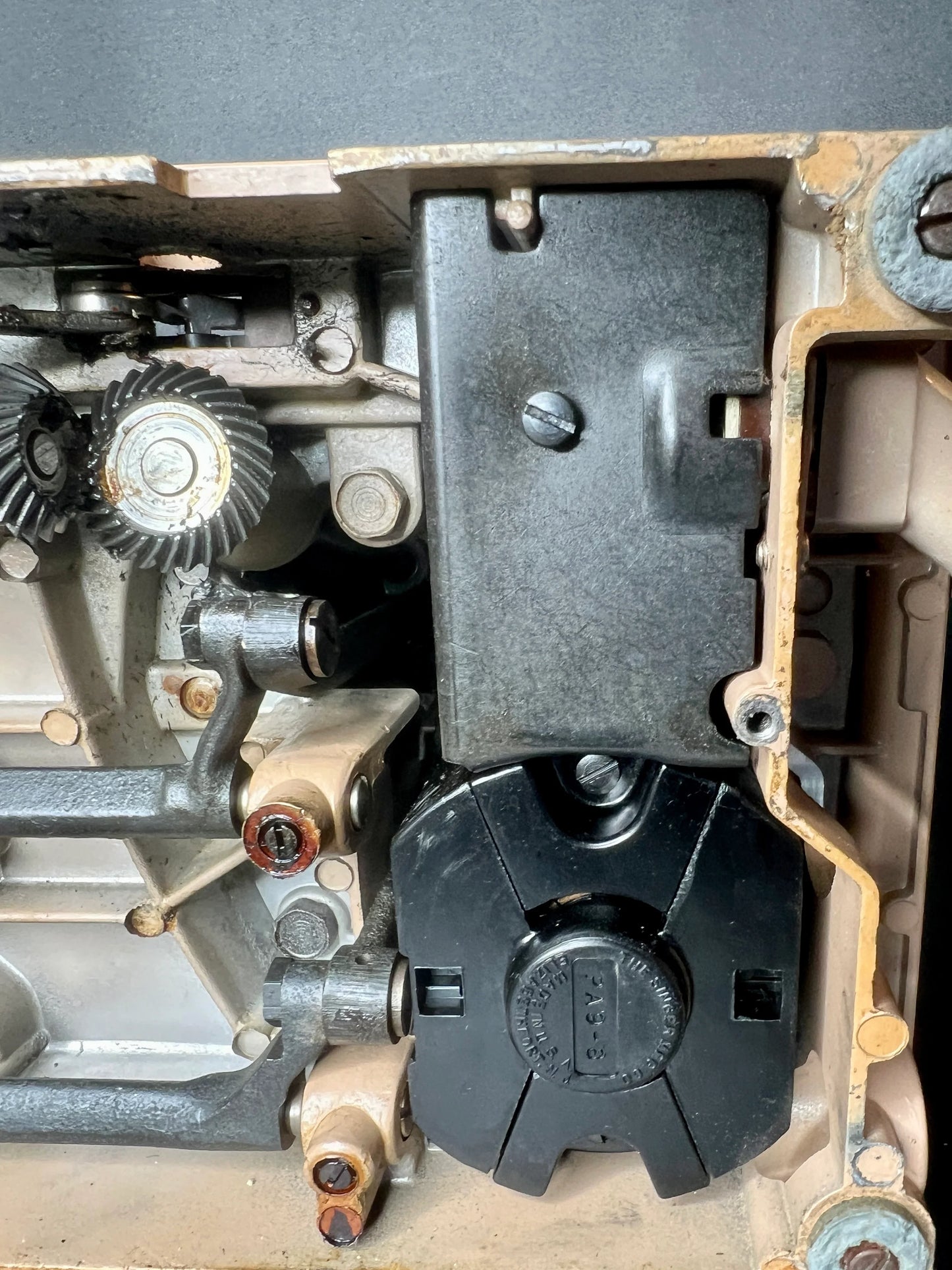 Close-up of mechanical components including gears and black plastic parts of Singer 403A Slant-O-Matic sewing machine