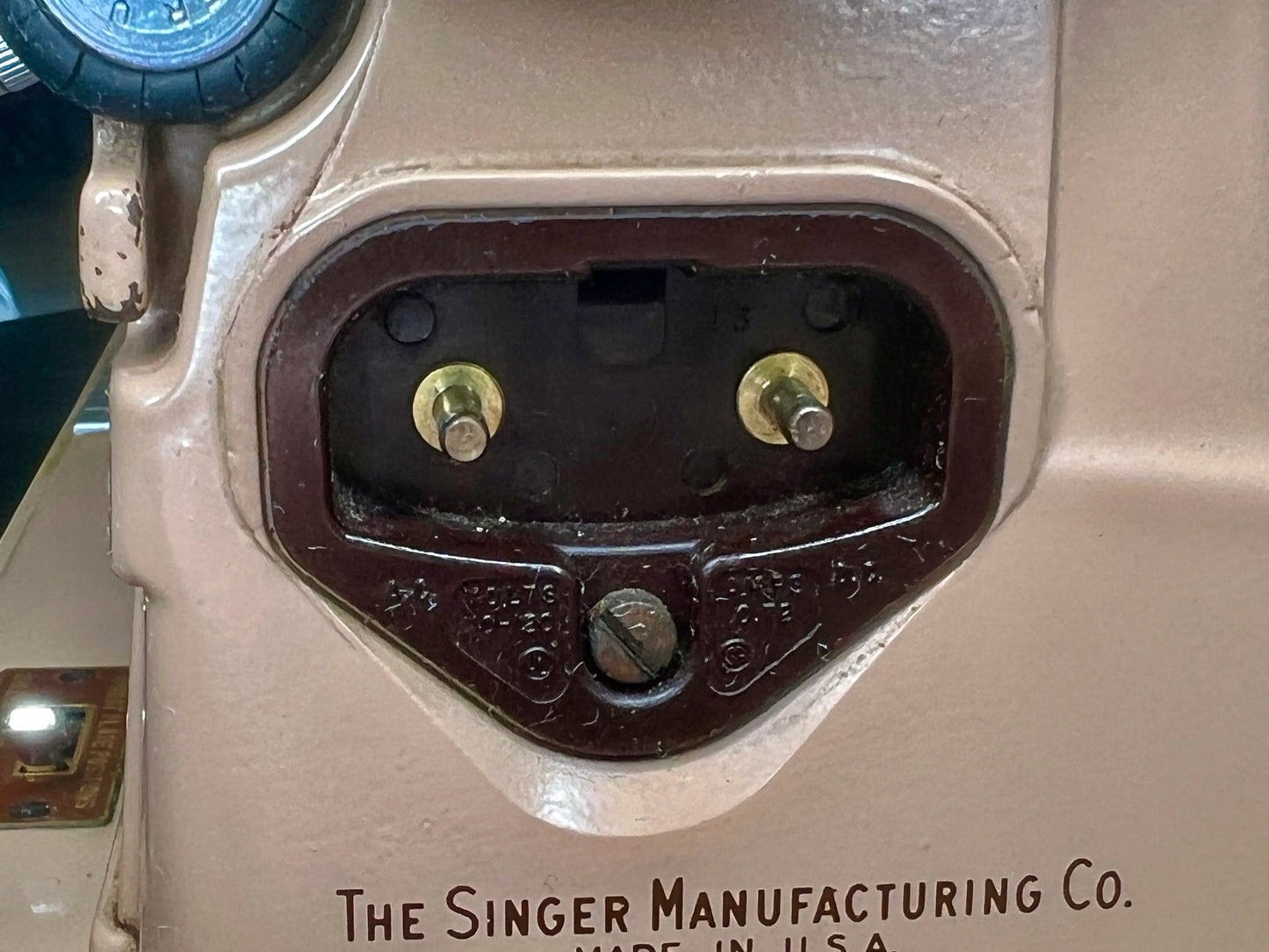 Close-up of a vintage Singer 403A Slant-o-Matic sewing machine in beige and brown.