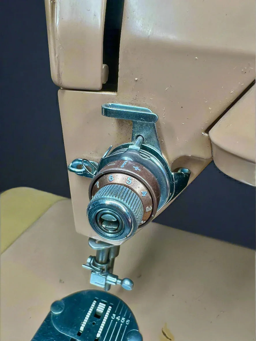 Close-up of a vintage Singer 403A Slant-o-Matic sewing machine's needle and thread mechanism.