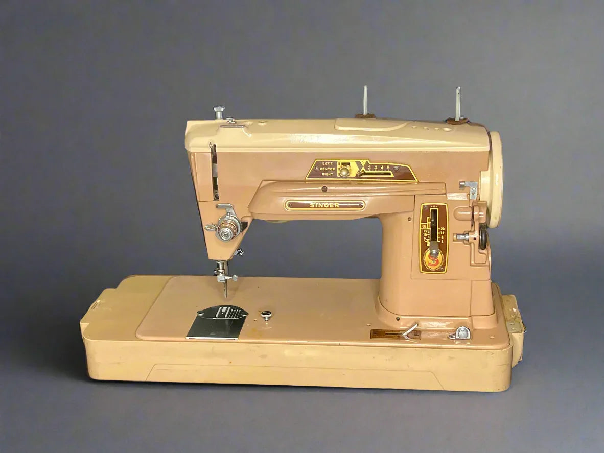 Full view of a vintage Singer 403A Slant-o-Matic sewing machine in beige and brown, displayed with its matching hard-shell carrying case and a small box of original Singer attachments for Class 403 machines.