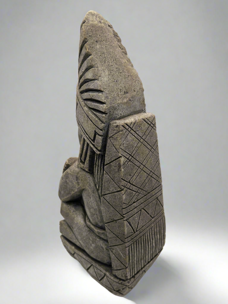 Ceramic sculpture with geometric patterns on a gray background