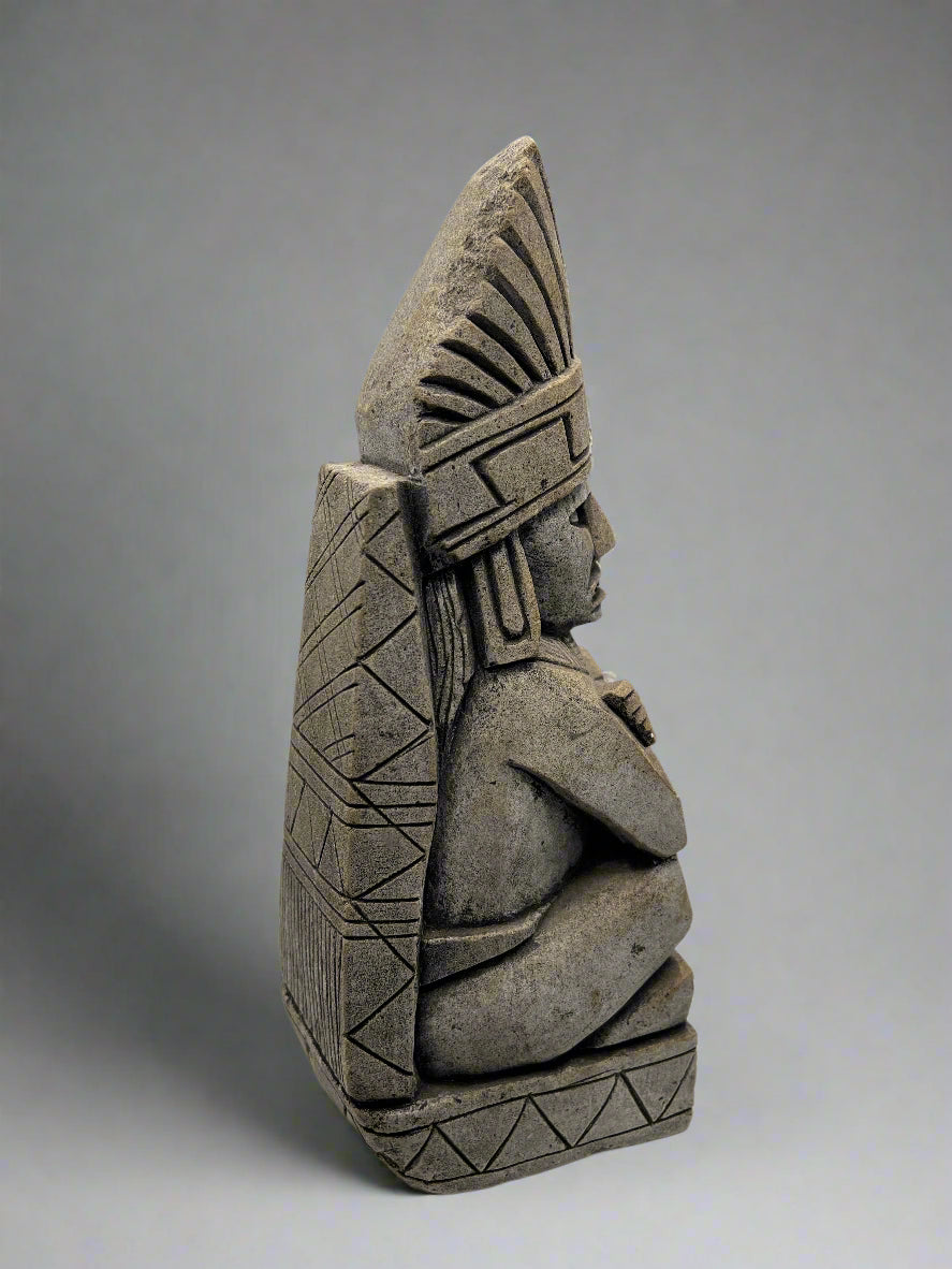 Stone status with geometric patterns on a white background