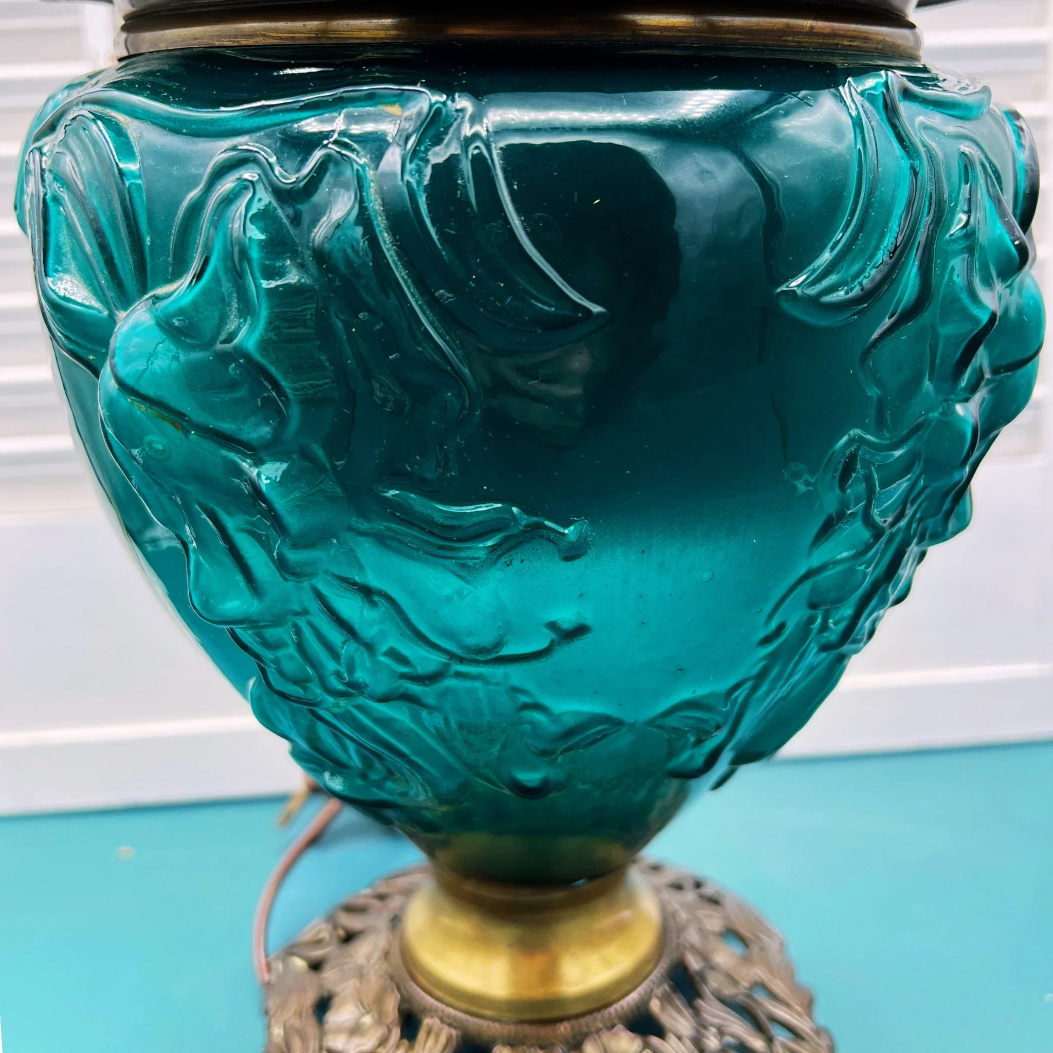 Antique Success converted oil lamp with hand-painted lily on emerald green glass.