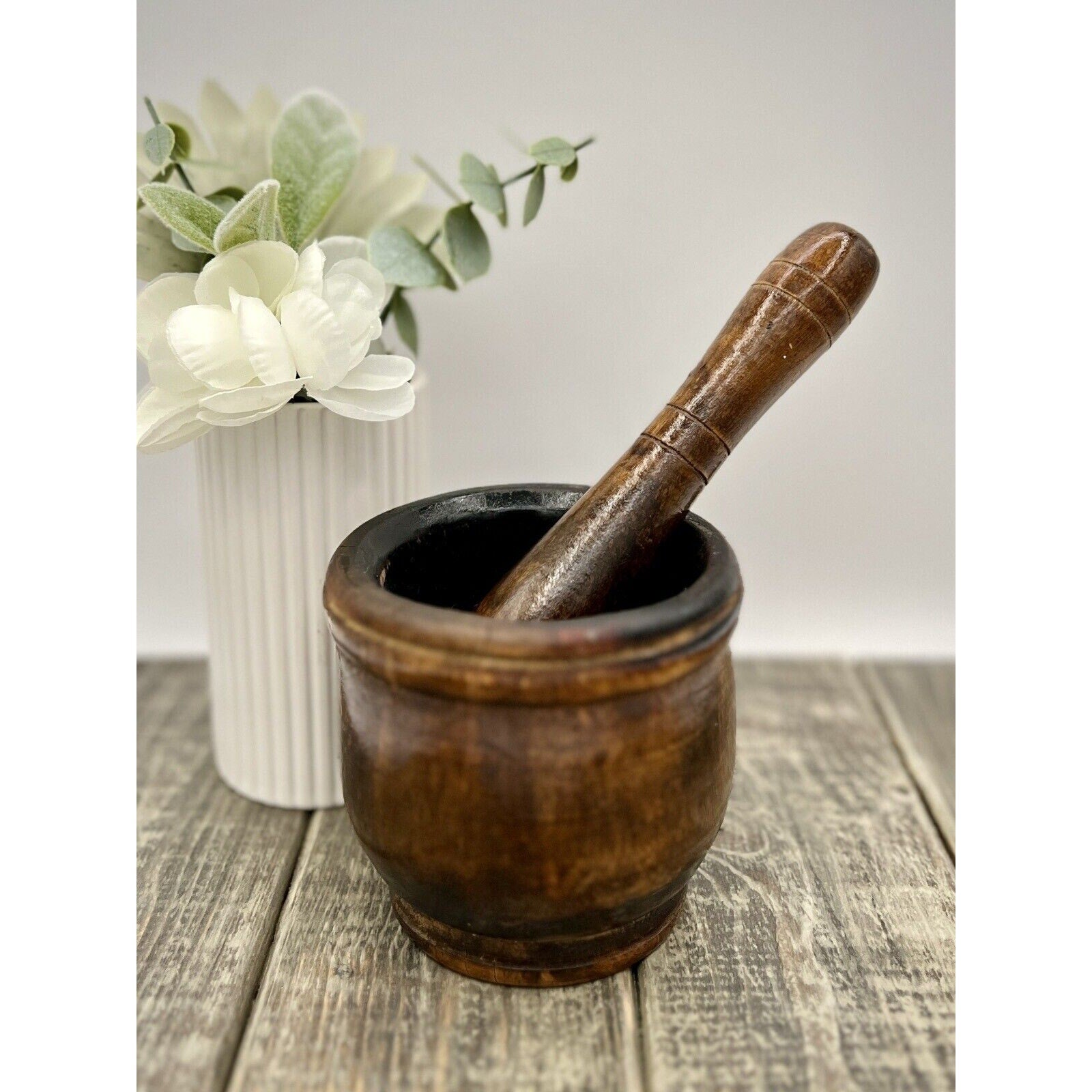 Antique dark wooden mortar and pestle with worn finish; mortar 3.5 in tall, pestle 6.25 in.