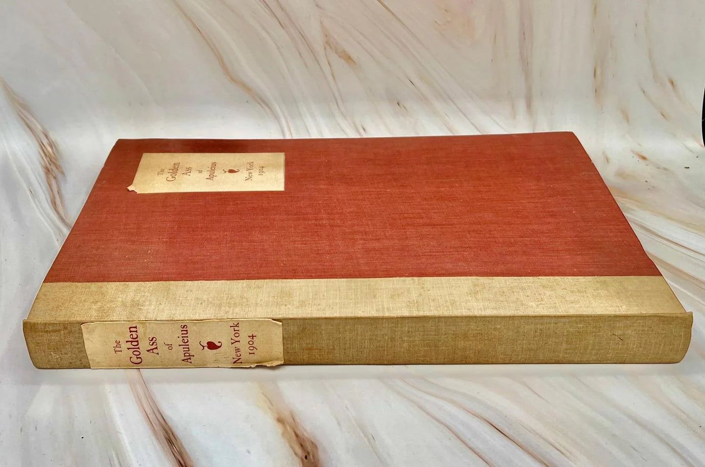 Gilt title on the spine of the 1904 The Golden Ass of Apuleius, showing the vellum binding and raised bands.