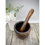 Antique wooden mortar and pestle in dark hardwood; mortar 3.5 in tall, pestle 6.25 in, heavily worn and aged.