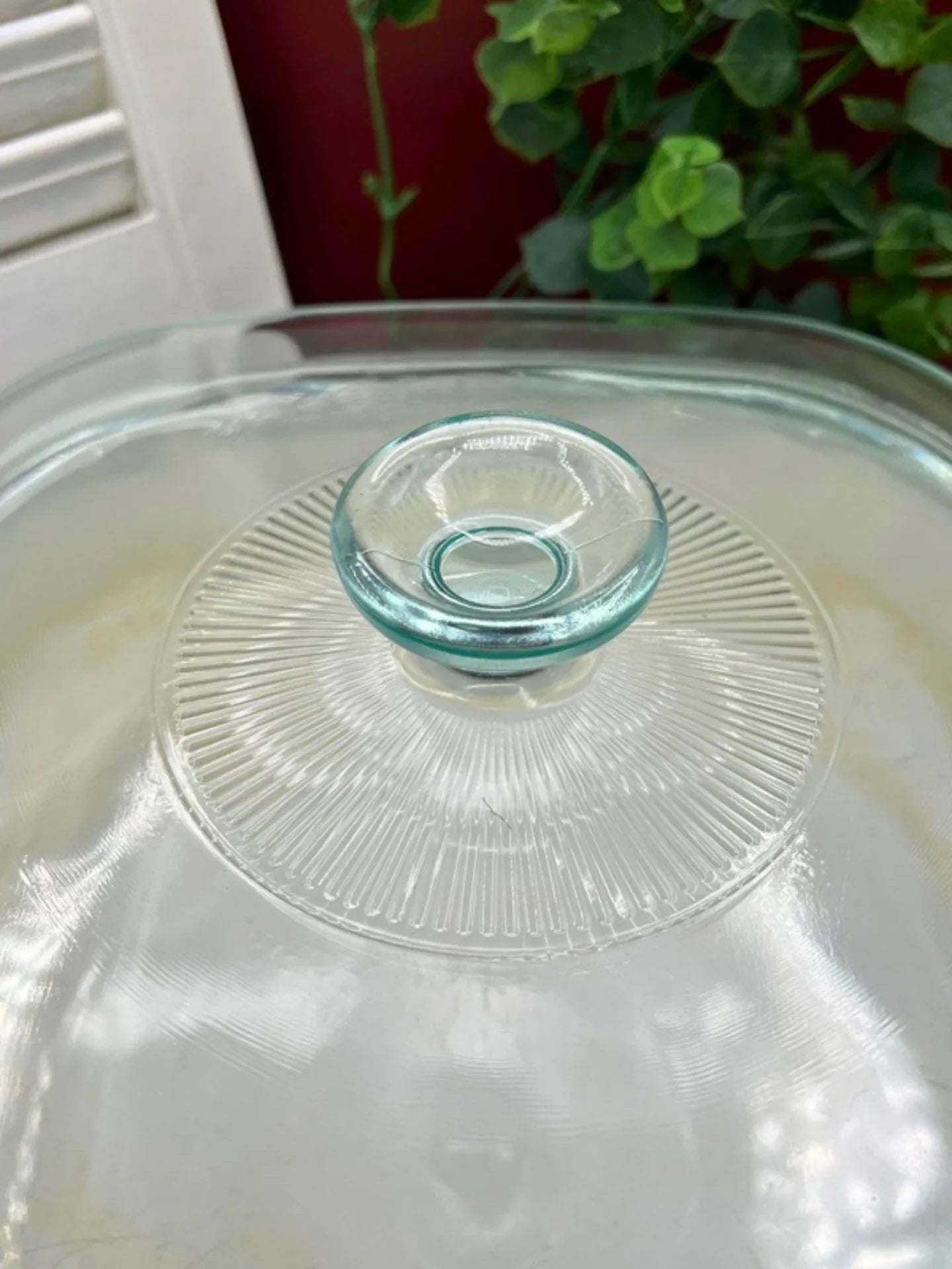Close-up of Pyrex A12C glass lid handle and ribbed design for vintage Corning Ware Le Romarin casserole dish.