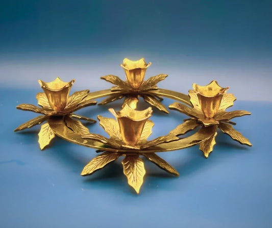 Gold floral candle holder on a blue background
