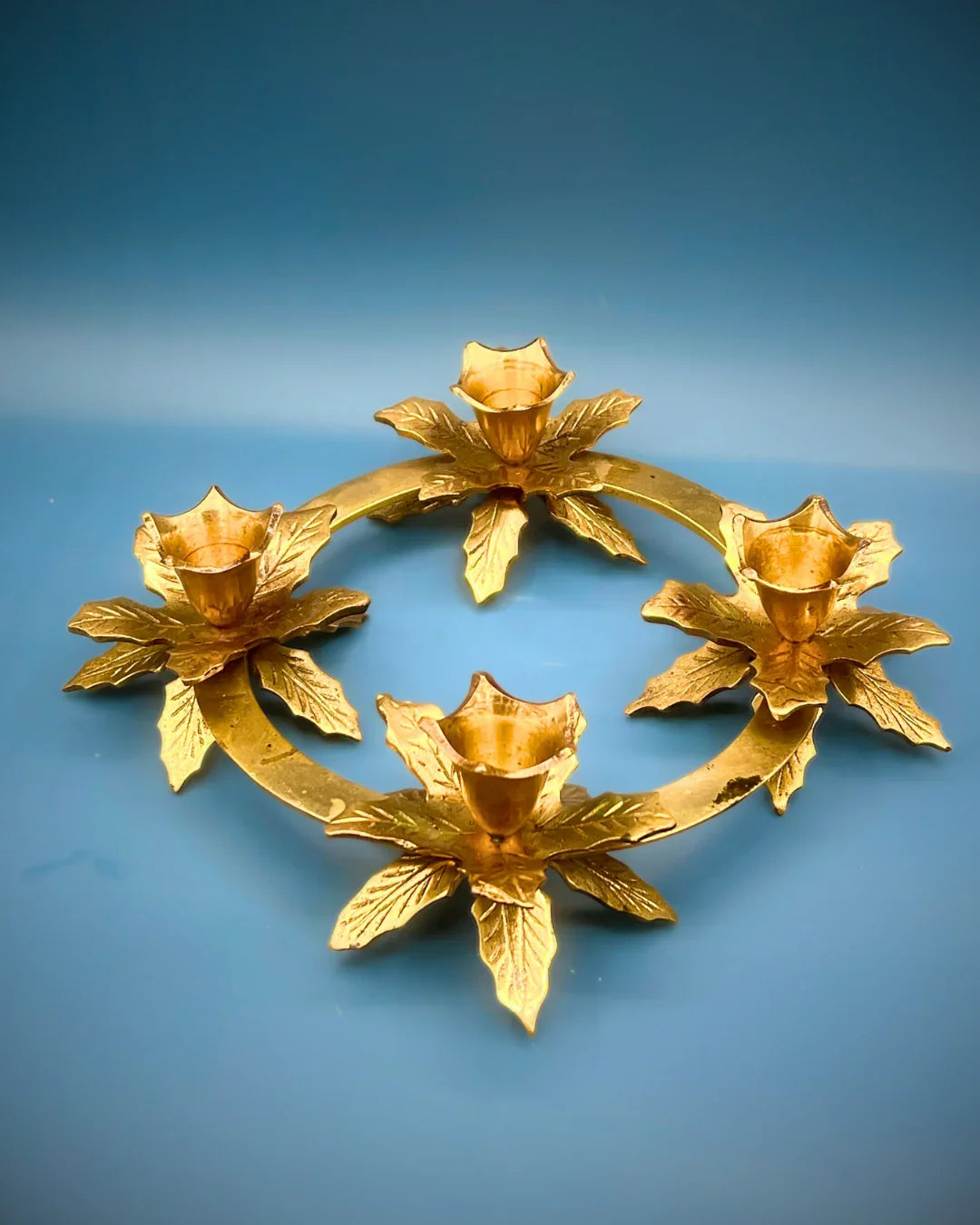Gold floral wreath on a blue background