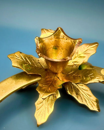 Gold-colored decorative item resembling a flower on a blue background