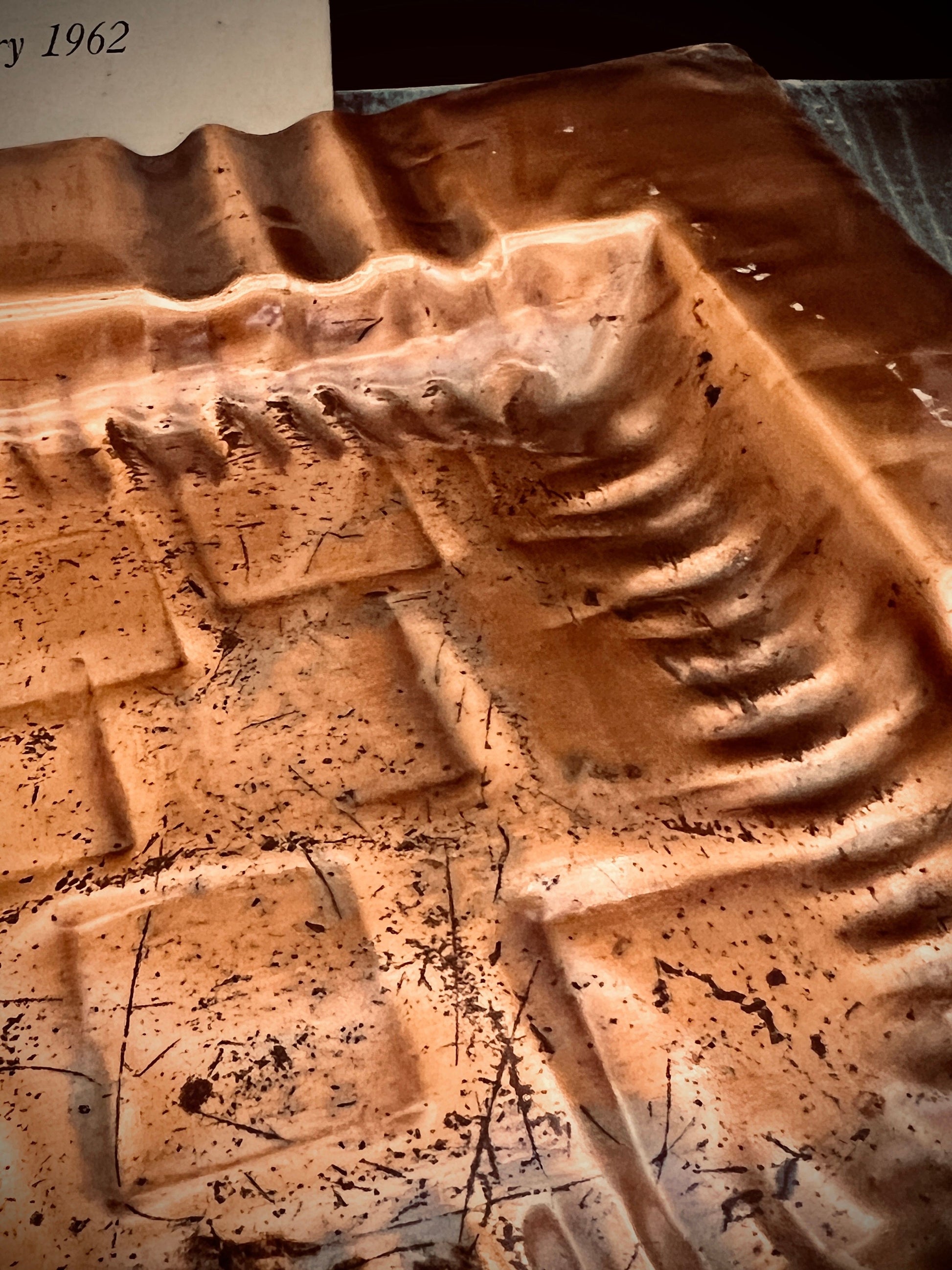 Close-up of patina and age wear on copper tray