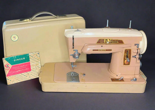 Full view of a vintage Singer 403A Slant-o-Matic sewing machine in beige and brown, displayed with its matching hard-shell carrying case and a small box of original Singer attachments for Class 403 machines. The machine shows some cosmetic wear.