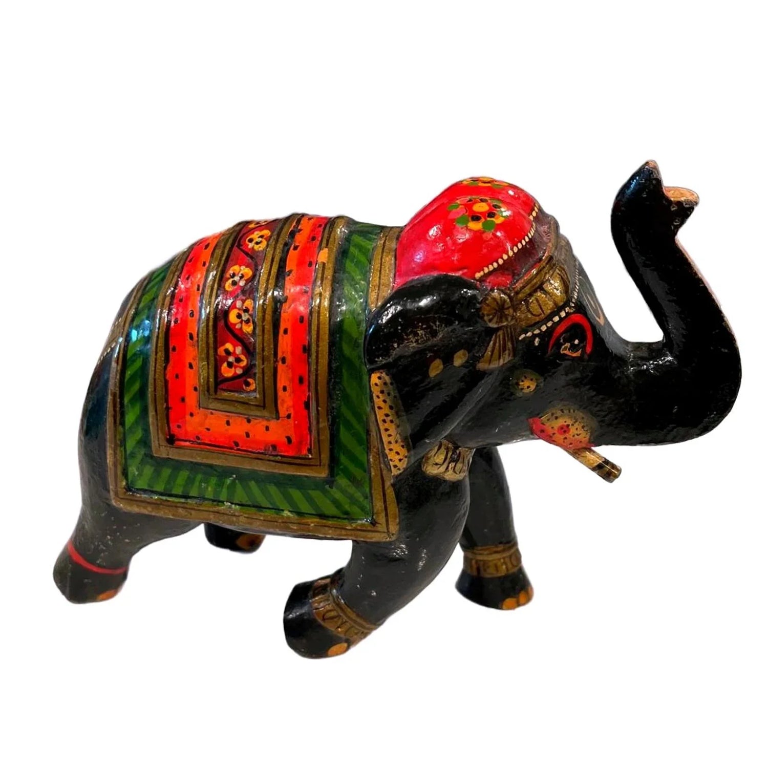 Side view of vintage hand-painted Indian wooden elephant statue with trunk up