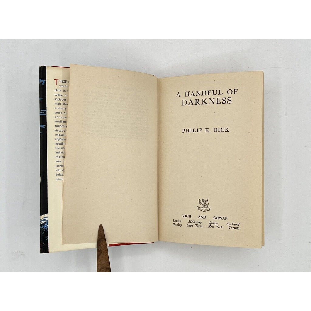 Open book titled 'A Handful of Darkness' by Philip K. Dick