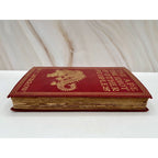 Red leather-bound first edition of The Ape, The Idiot & Other People by W. C. Morrow, gilt dragon cover.