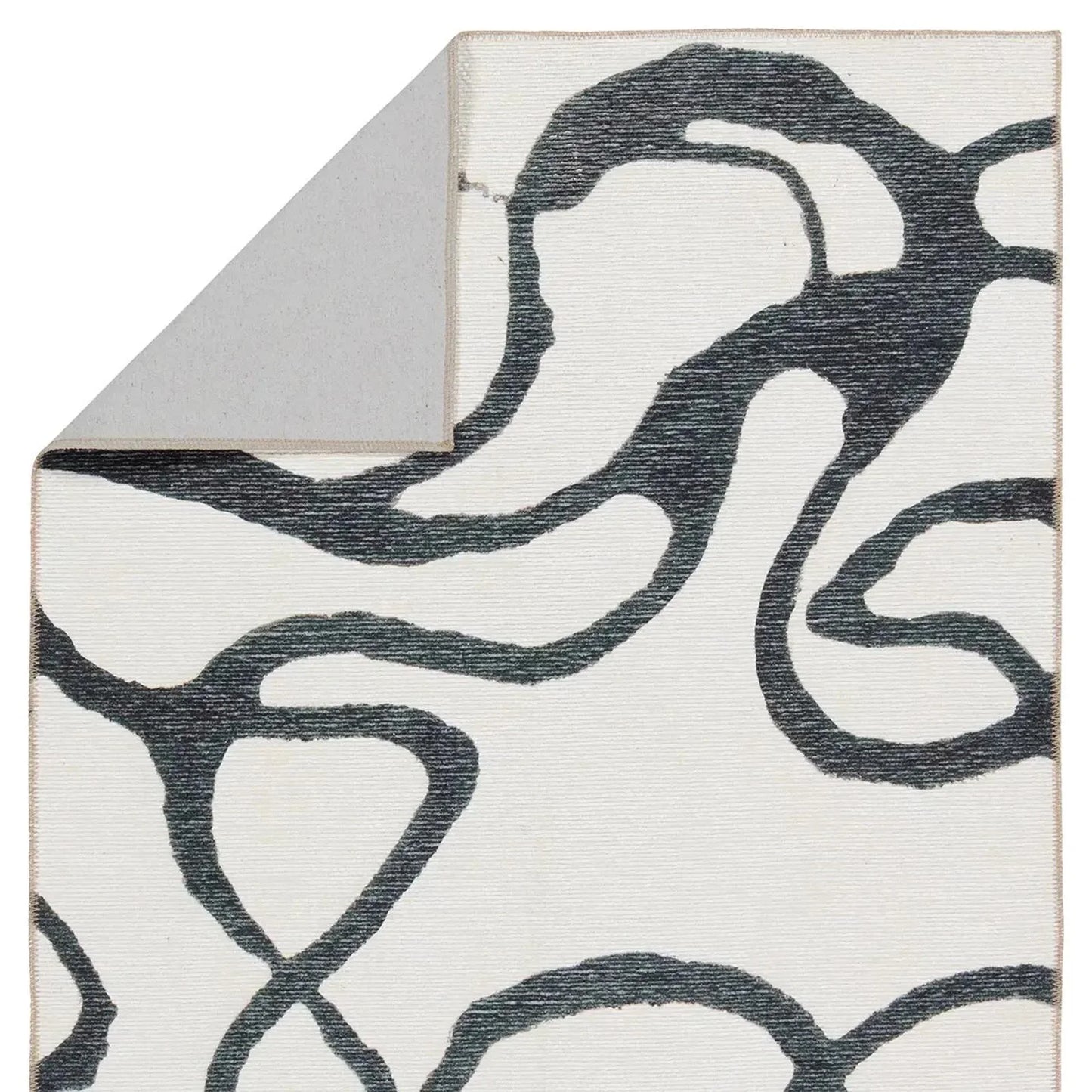 Close-up of a rug with abstract black pattern on white background
