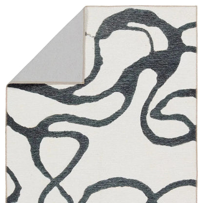 Close-up of a rug with abstract black pattern on white background