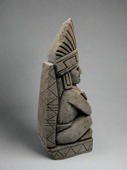 Stone status with geometric patterns on a white background
